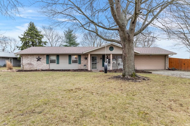 single story home with a front yard, fence, driveway, an attached garage, and brick siding