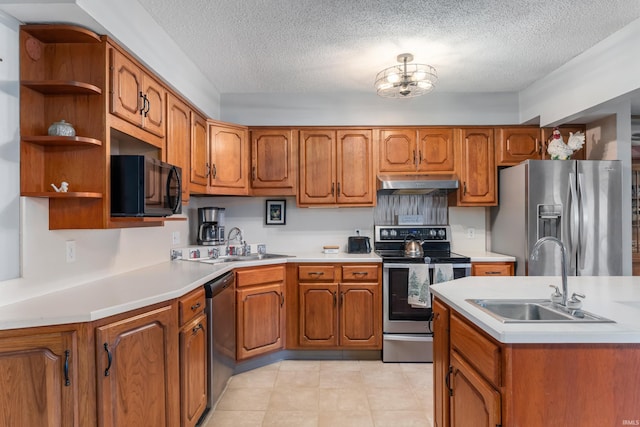 kitchen with under cabinet range hood, open shelves, appliances with stainless steel finishes, and a sink