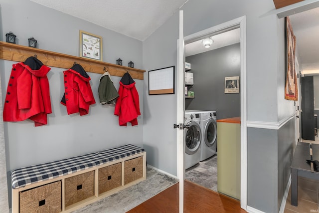 mudroom featuring wood finished floors, baseboards, and washer and clothes dryer