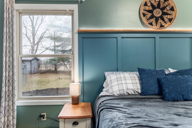 bedroom with a decorative wall and wainscoting