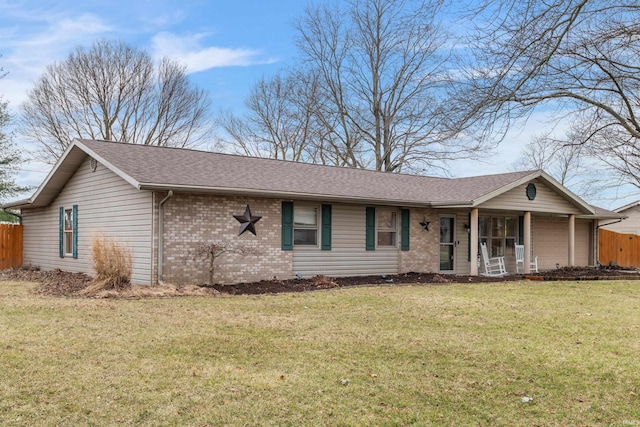 single story home featuring brick siding, fence, roof with shingles, a front yard, and covered porch