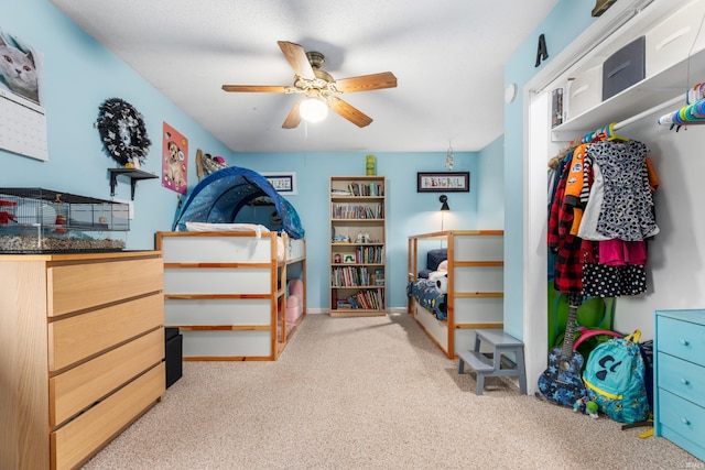 bedroom featuring a ceiling fan and carpet