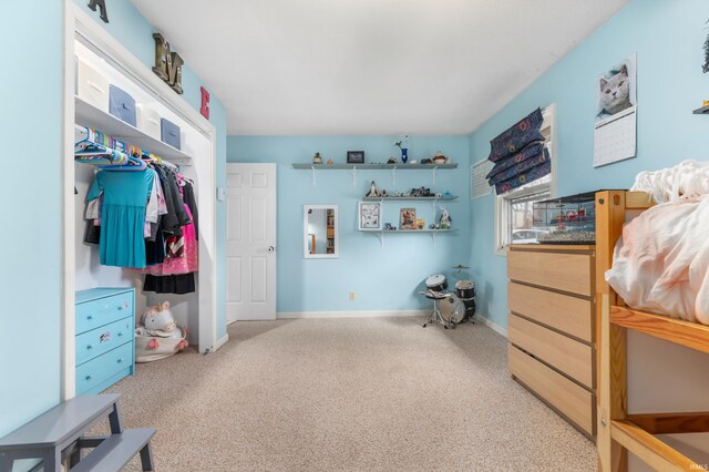 carpeted bedroom featuring baseboards