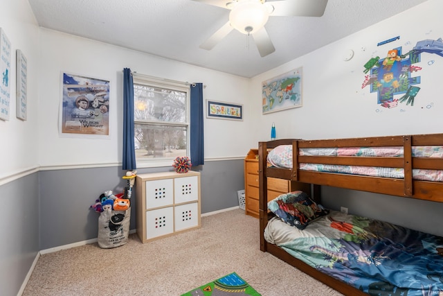 bedroom with ceiling fan, baseboards, and carpet floors