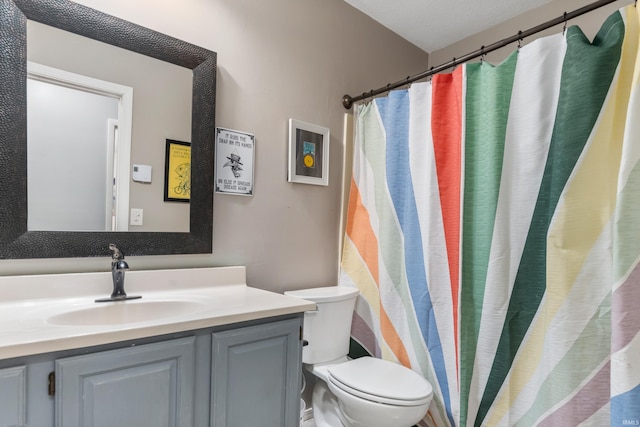 full bath featuring toilet and vanity