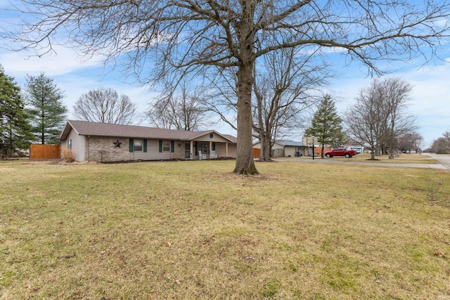 single story home with brick siding, a front lawn, and fence