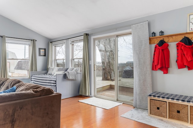 doorway to outside featuring vaulted ceiling and wood finished floors