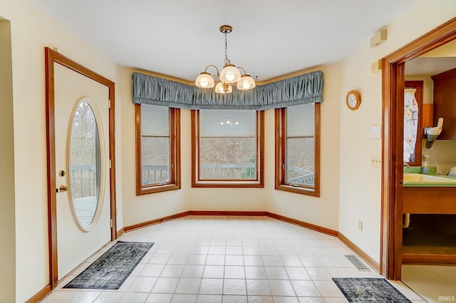 foyer with visible vents, baseboards, and an inviting chandelier