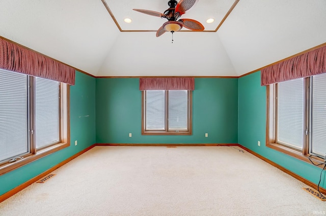 unfurnished room with visible vents, carpet flooring, baseboards, and vaulted ceiling