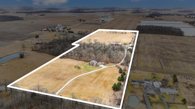 birds eye view of property with a rural view