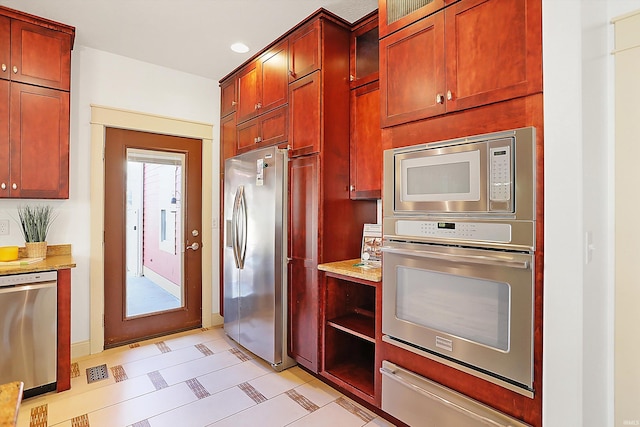 kitchen featuring a warming drawer, appliances with stainless steel finishes, recessed lighting, and dark brown cabinets