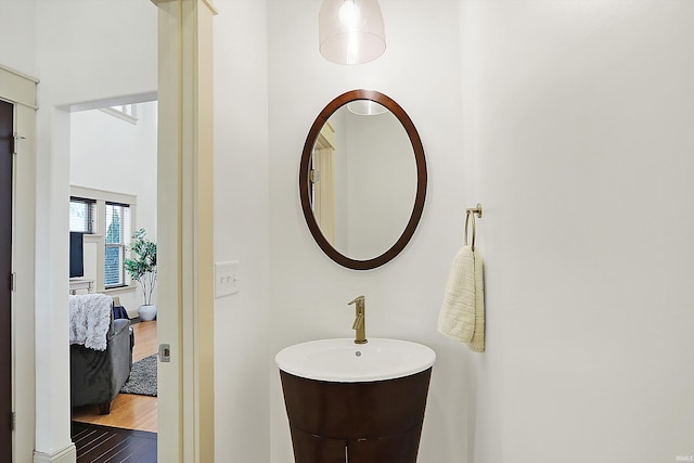 ensuite bathroom featuring ensuite bath and wood finished floors