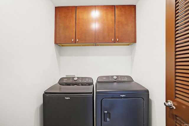 laundry area featuring cabinet space and washer and clothes dryer