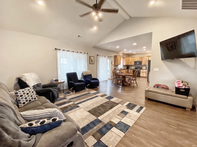 living room with visible vents, beam ceiling, high vaulted ceiling, and light wood finished floors