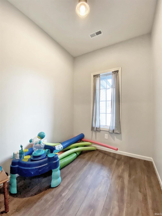 game room featuring wood finished floors, visible vents, and baseboards