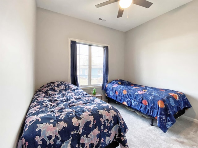 carpeted bedroom with visible vents and ceiling fan