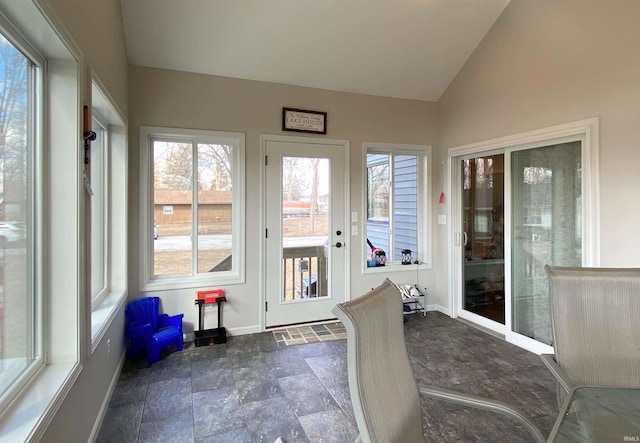 sunroom / solarium with a wealth of natural light and vaulted ceiling