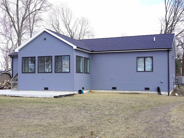 back of house with crawl space, a patio area, and a yard