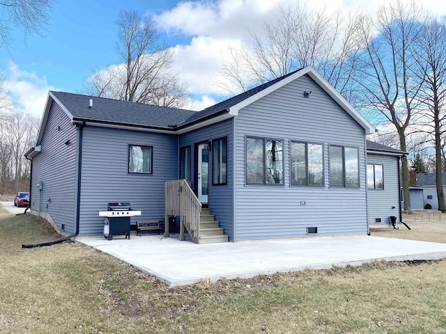 rear view of property featuring a patio area, crawl space, a lawn, and roof with shingles