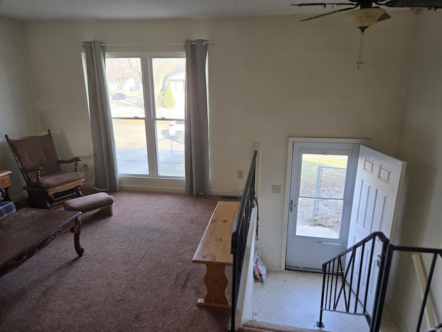 sitting room featuring an upstairs landing, carpet, and a wealth of natural light