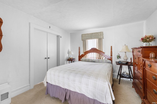 bedroom with a closet and light carpet