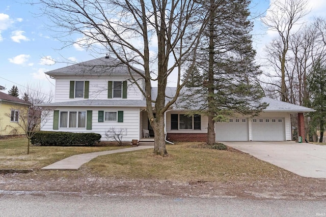 traditional home with a garage, brick siding, and driveway