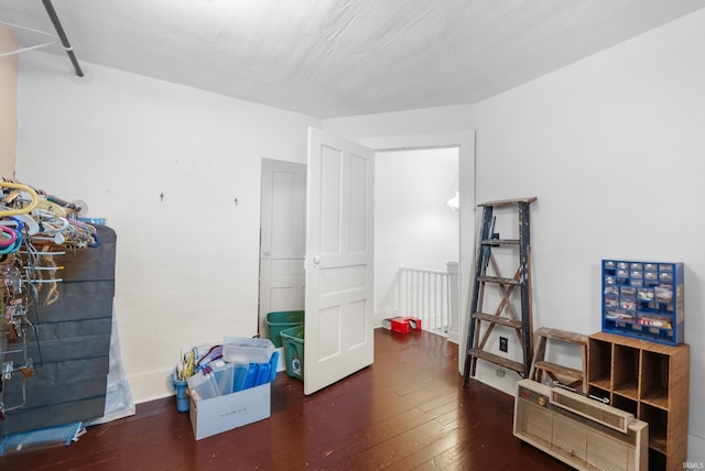 interior space featuring baseboards and wood-type flooring