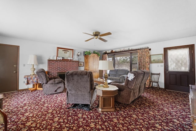 carpeted living area featuring a brick fireplace, baseboards, and a ceiling fan