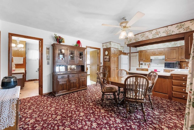 dining space featuring baseboards, a ceiling fan, and wallpapered walls