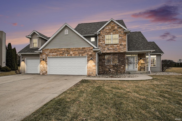 view of front facade featuring driveway, roof with shingles, an attached garage, stone siding, and a lawn