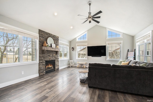 living area with dark wood finished floors, visible vents, a wealth of natural light, and a large fireplace