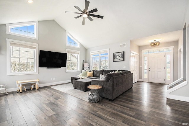 living area featuring baseboards, dark wood-style floors, visible vents, and high vaulted ceiling