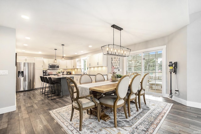 dining room with dark wood-style floors, recessed lighting, and baseboards