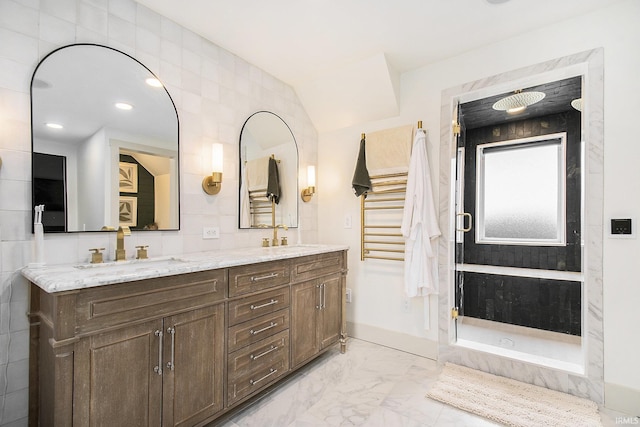 full bath featuring double vanity, a stall shower, marble finish floor, tile walls, and a sink