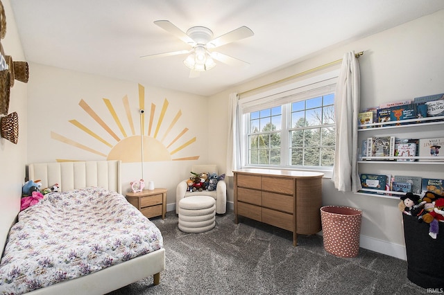 bedroom featuring a ceiling fan, baseboards, and dark carpet