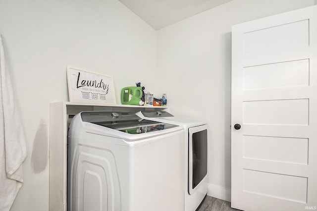 laundry area featuring washer and dryer, laundry area, and wood finished floors