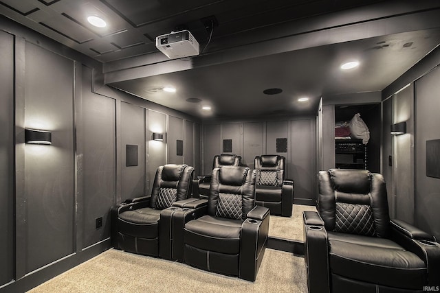 carpeted home theater room with a decorative wall and recessed lighting