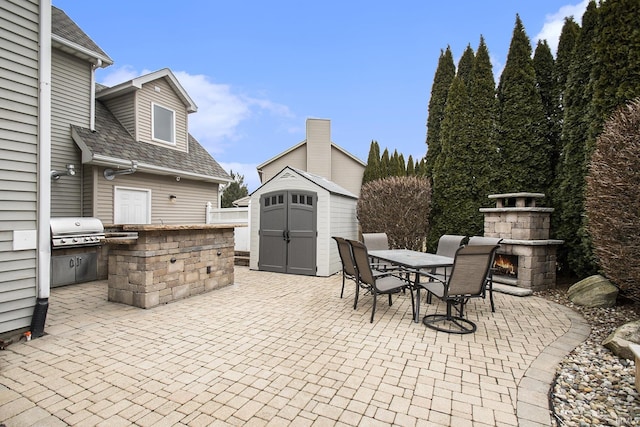 view of patio / terrace with an outdoor stone fireplace, outdoor dining area, a storage shed, an outdoor structure, and area for grilling