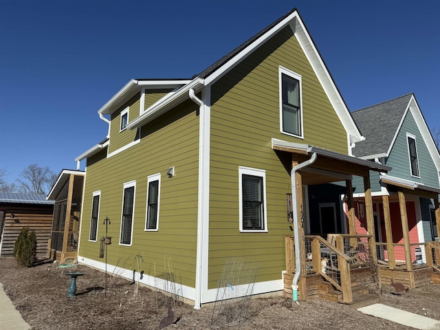 view of side of home featuring a porch