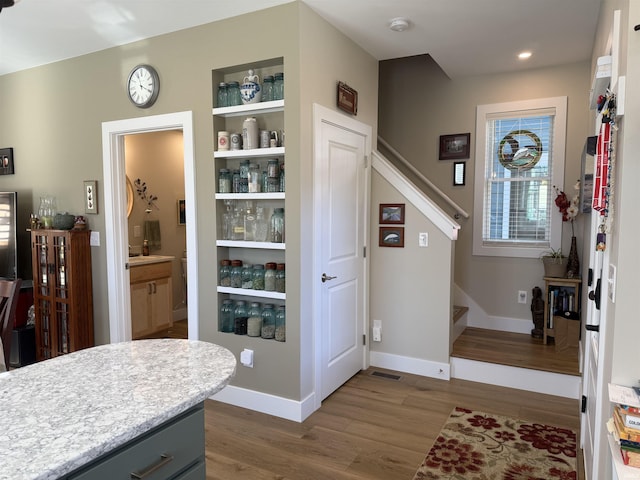 interior space featuring stairway, recessed lighting, dark wood-type flooring, and baseboards