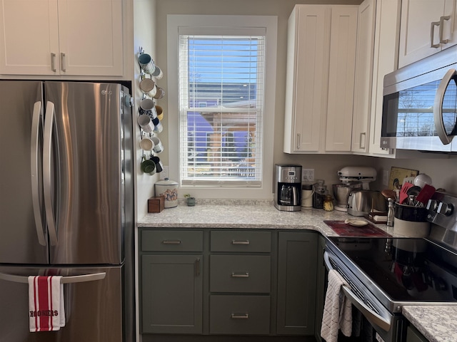 kitchen featuring white cabinetry, gray cabinetry, and stainless steel appliances