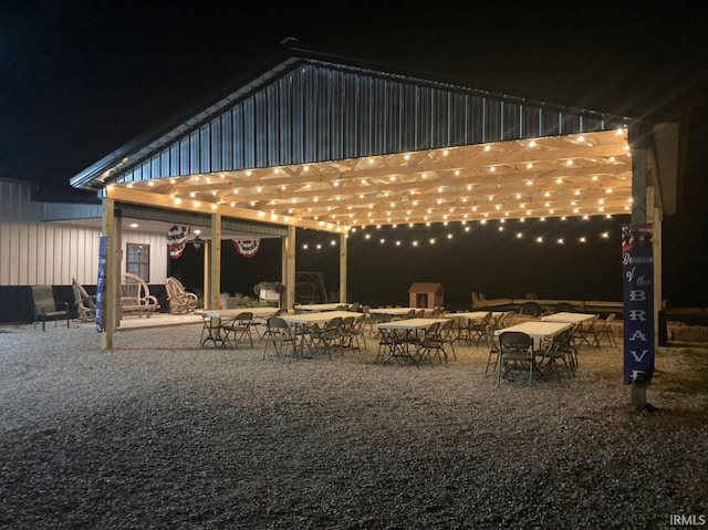 6889 N County Road 775 E, Grandview, IN 47615 - back of house at twilight with a patio and a pergola
