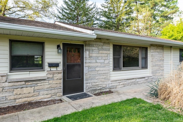 view of exterior entry with stone siding