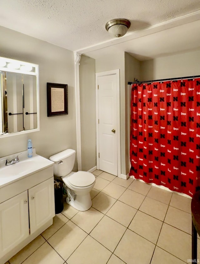 bathroom with tile patterned floors, toilet, a textured ceiling, a shower with shower curtain, and vanity