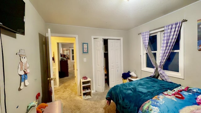 carpeted bedroom with a closet and a textured ceiling