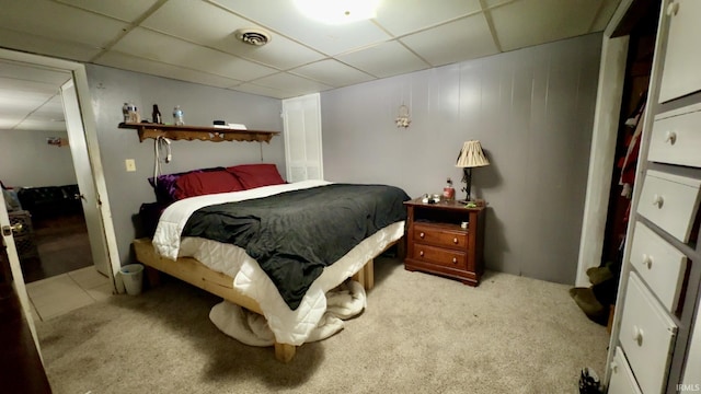 carpeted bedroom featuring visible vents and a paneled ceiling