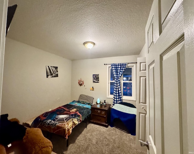 bedroom with a textured ceiling and carpet floors