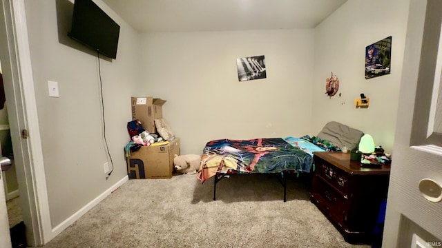 bedroom featuring carpet and baseboards