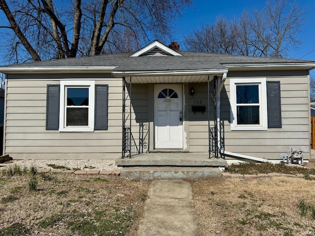 bungalow-style house with roof with shingles