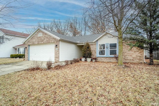 single story home with concrete driveway, a garage, and brick siding